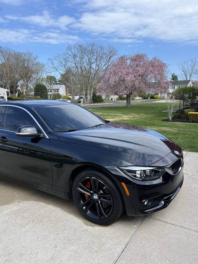 Black sedan freshly detailed in a driveway